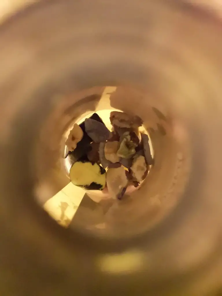 A view looking down into a plastic bottle, which contains scraps of leftover soap.