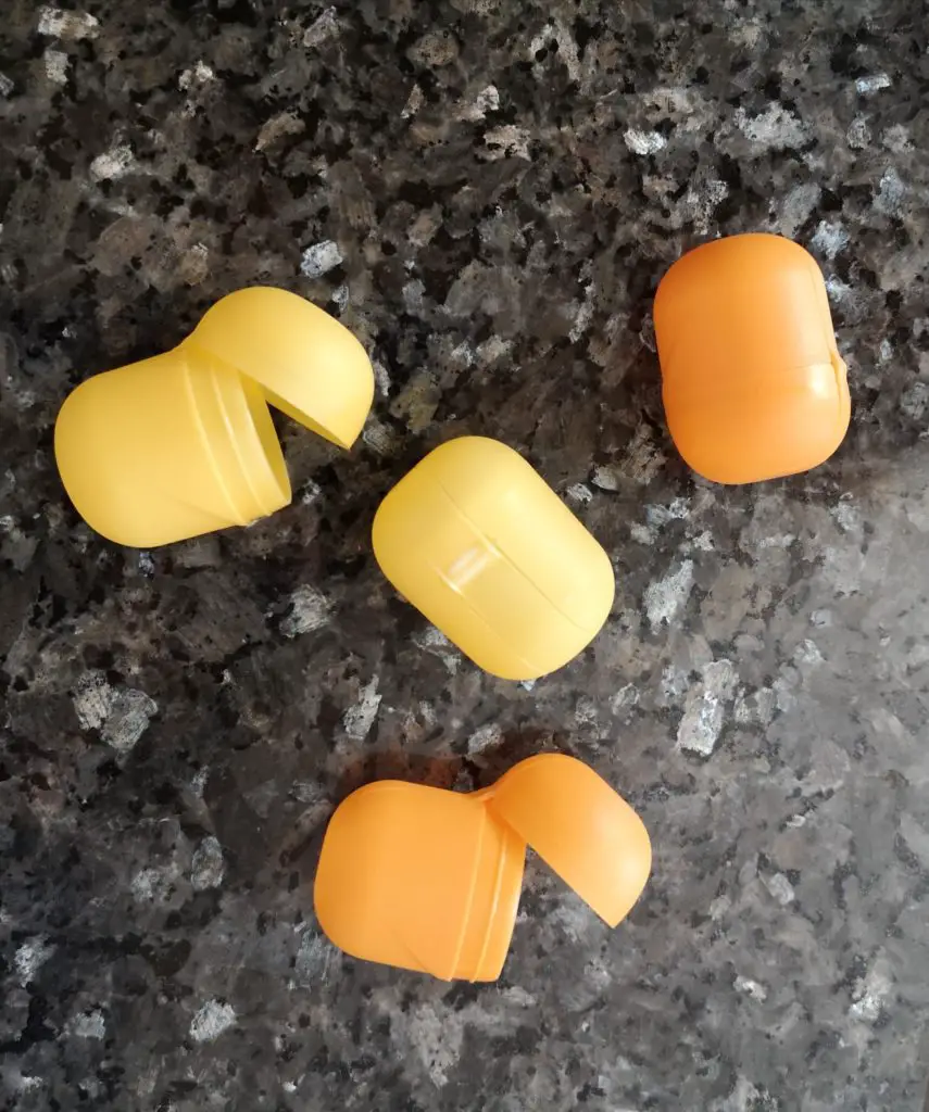 Four empty Kinder Egg capsules