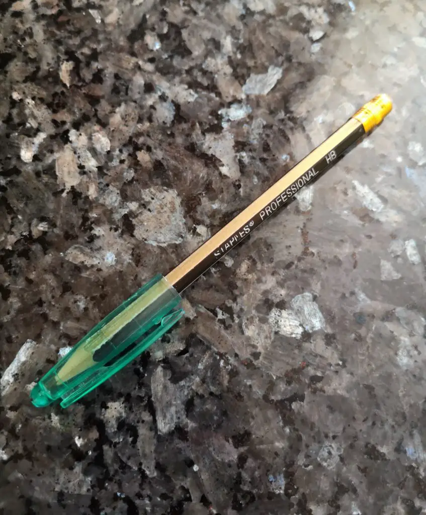 A pen lid on a pencil