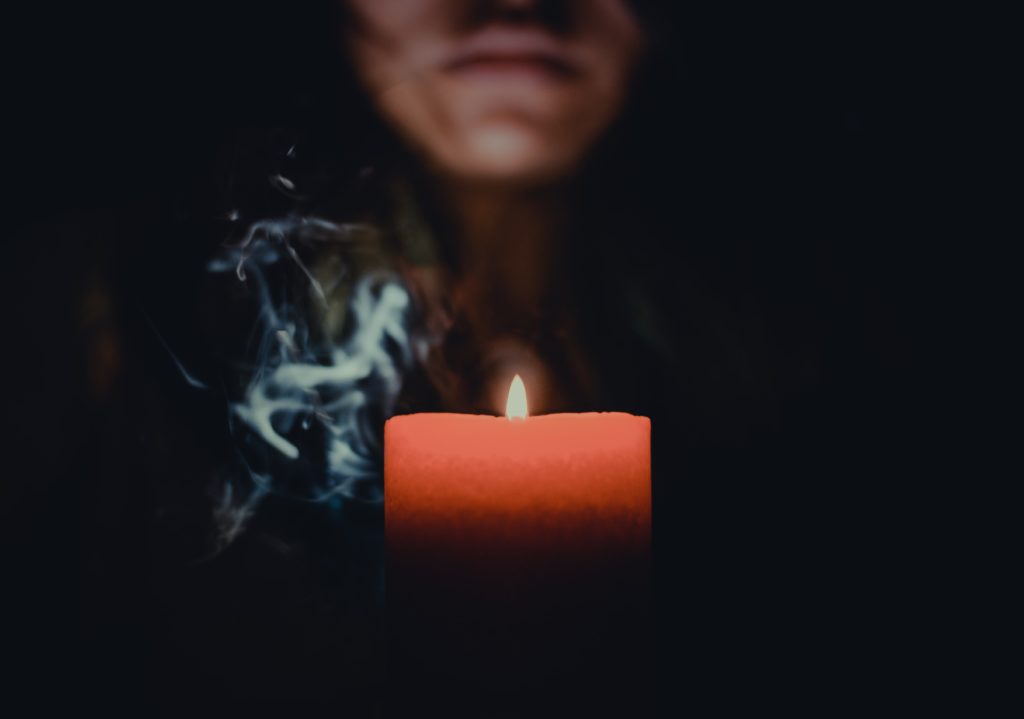 A woman about to blow out a candle.