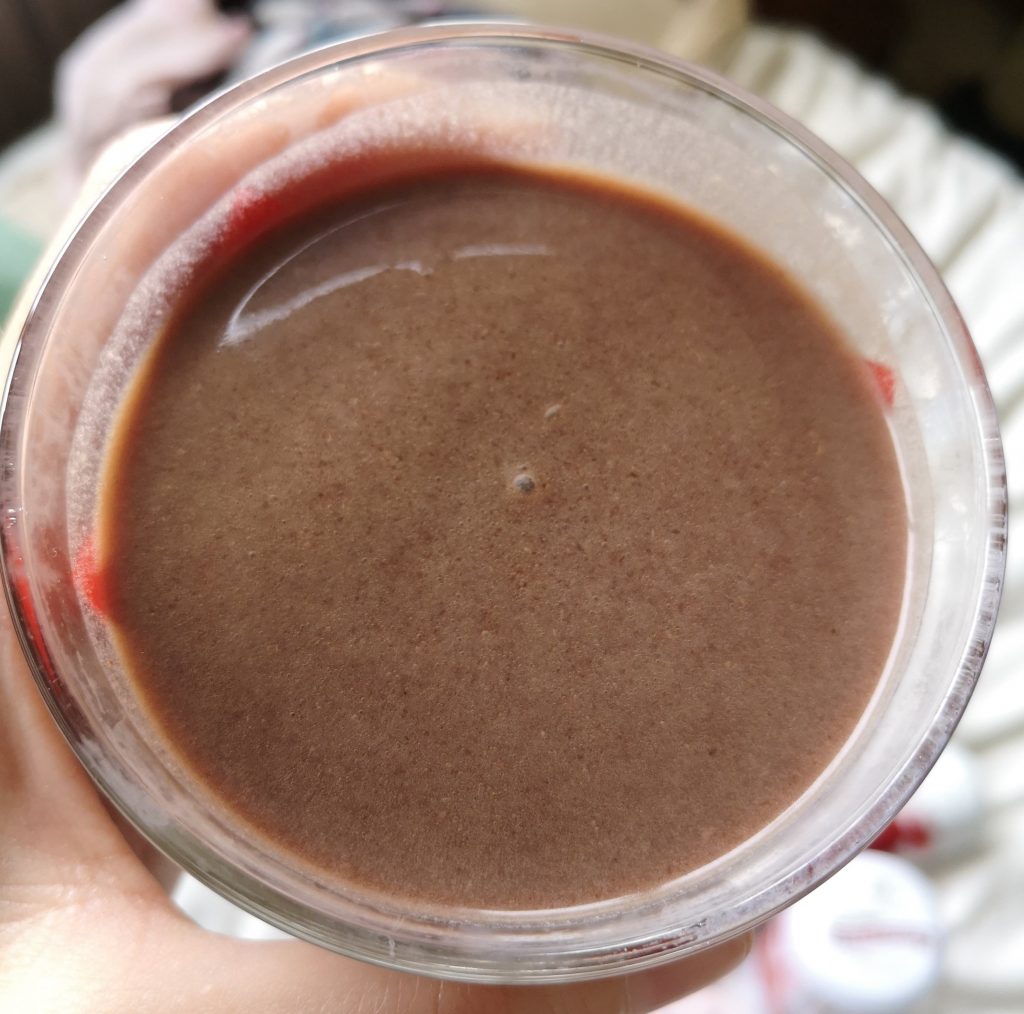 Close up of the chocolate protein shake in a glass.