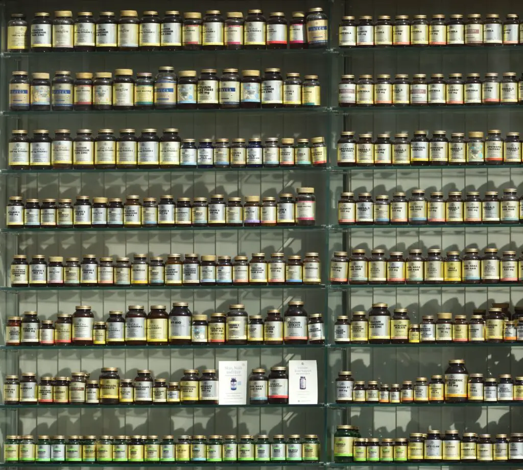 Shelves containing hundreds of bottles of vitamin and mineral supplements