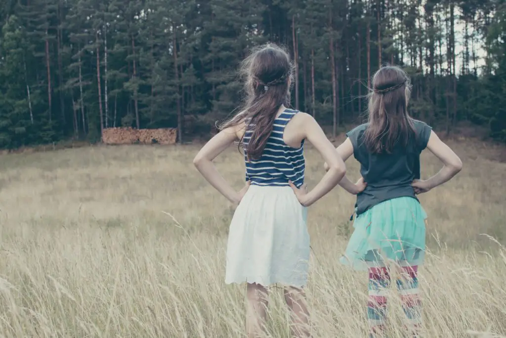 Two girls standing with their hands on their hips