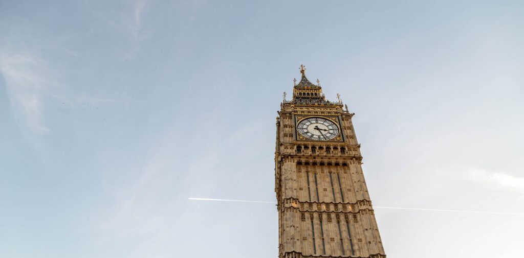 A view of Big Ben clock tower against a blue sky.