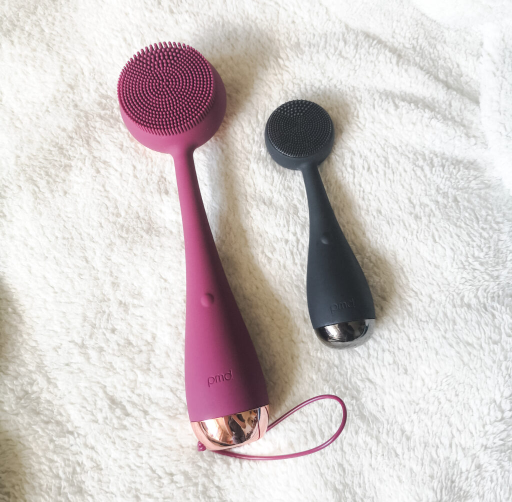 The PMD Clean Body laid alongside the original PMD Clean facial cleansing device, to show the size difference.