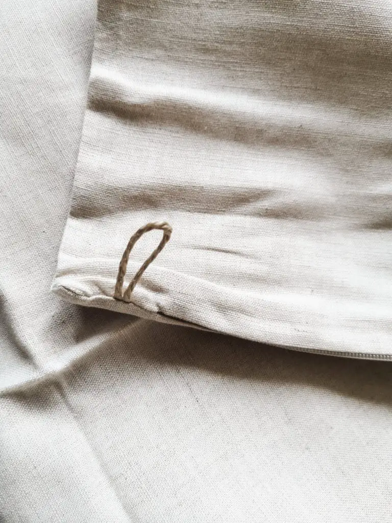 A close up of the hanging loop on an ATLINIA linen laundry bag.