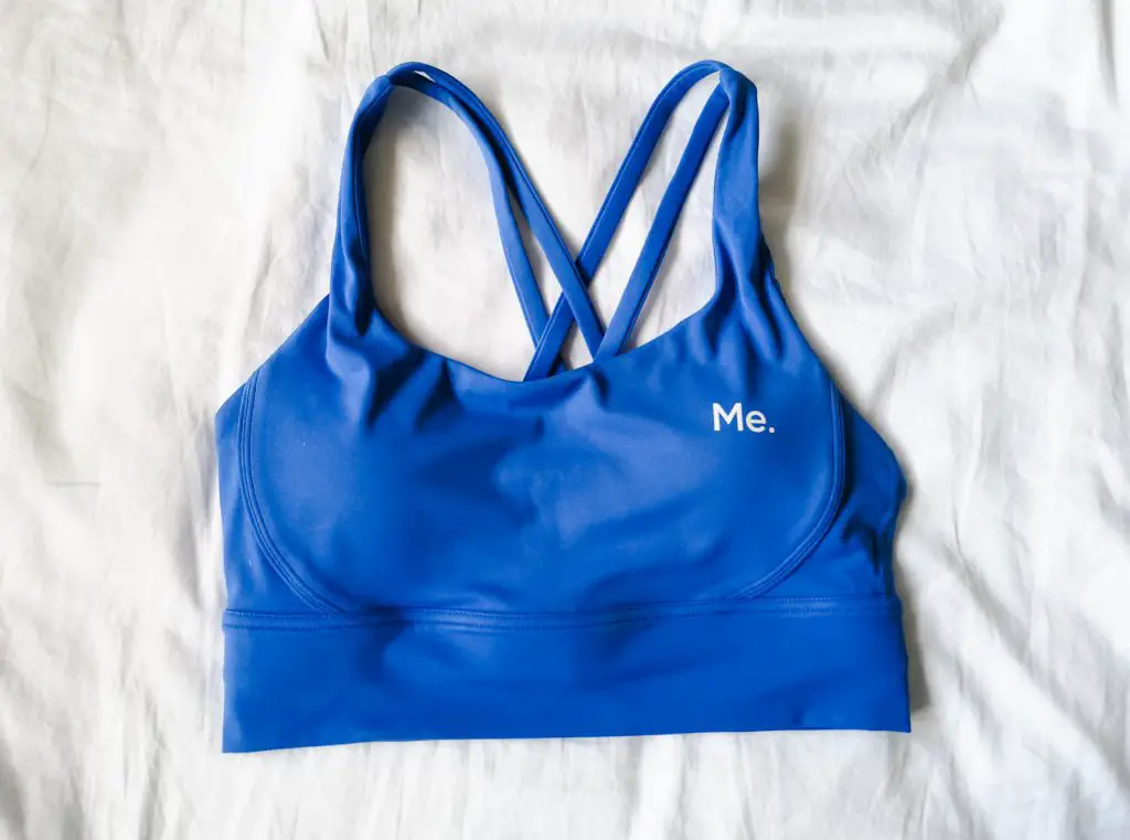 A blue sports bra with the 'Me.' logo.