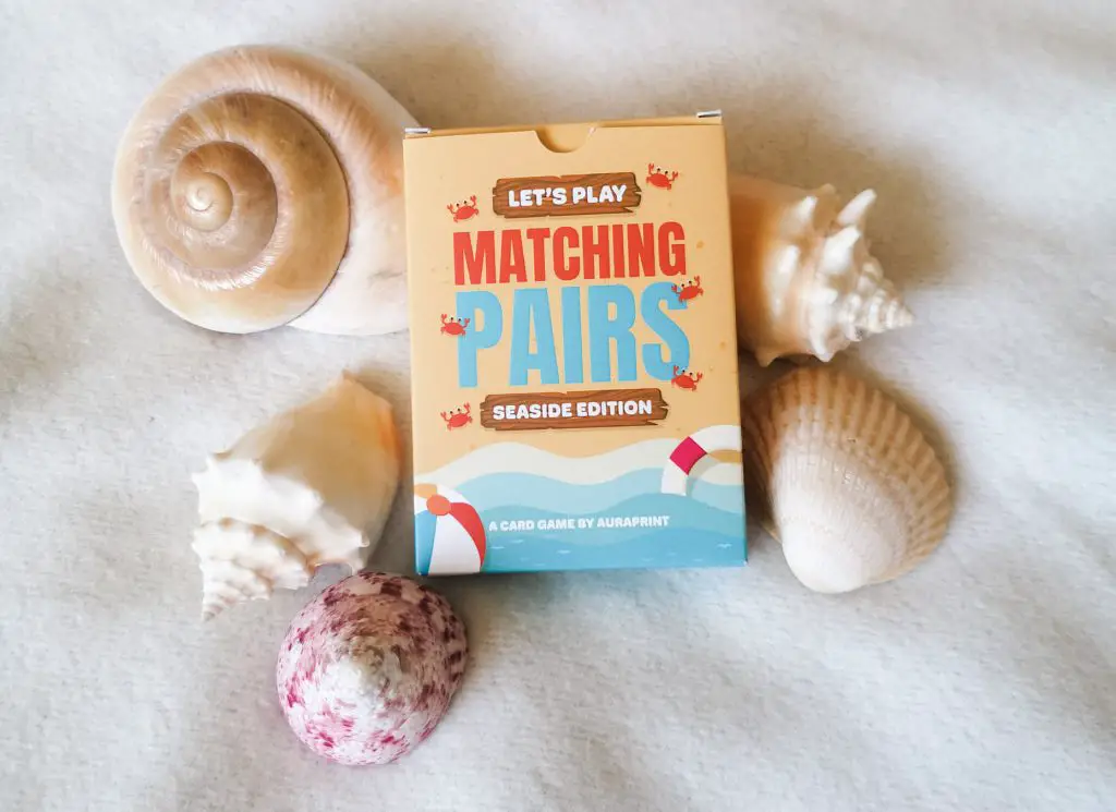 A pack of 'Matching Pairs' cards, seaside edition. It is surrounded by seashells.