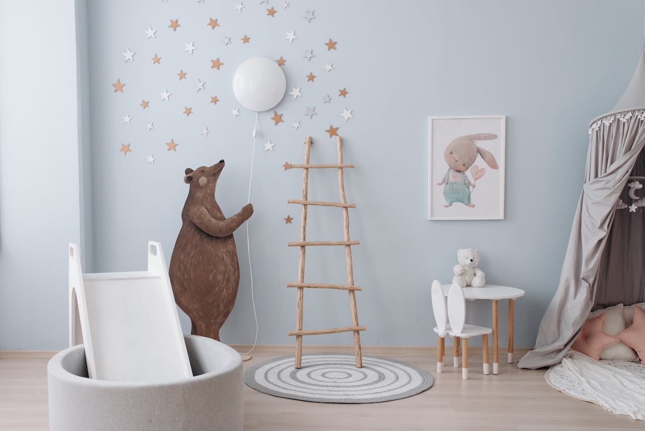 A nursery decorated with an animal theme and pastel colours.