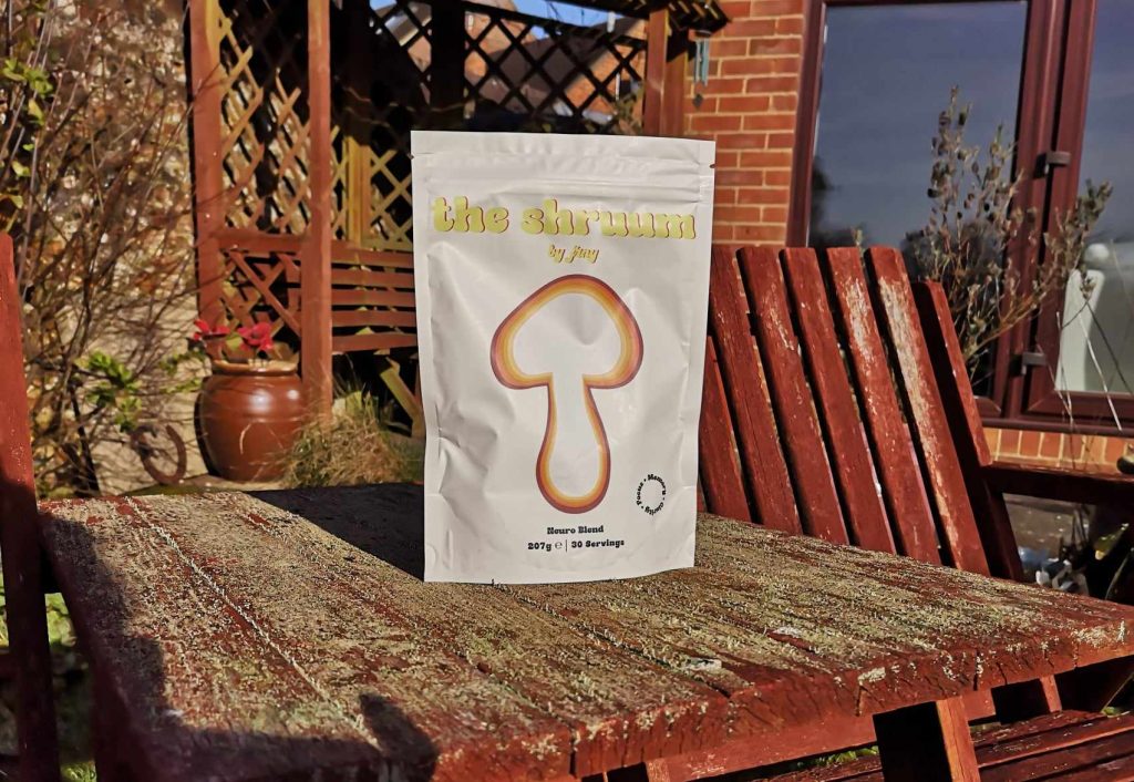 A pouch of The Shruum by Jrny on a bench outdoors.