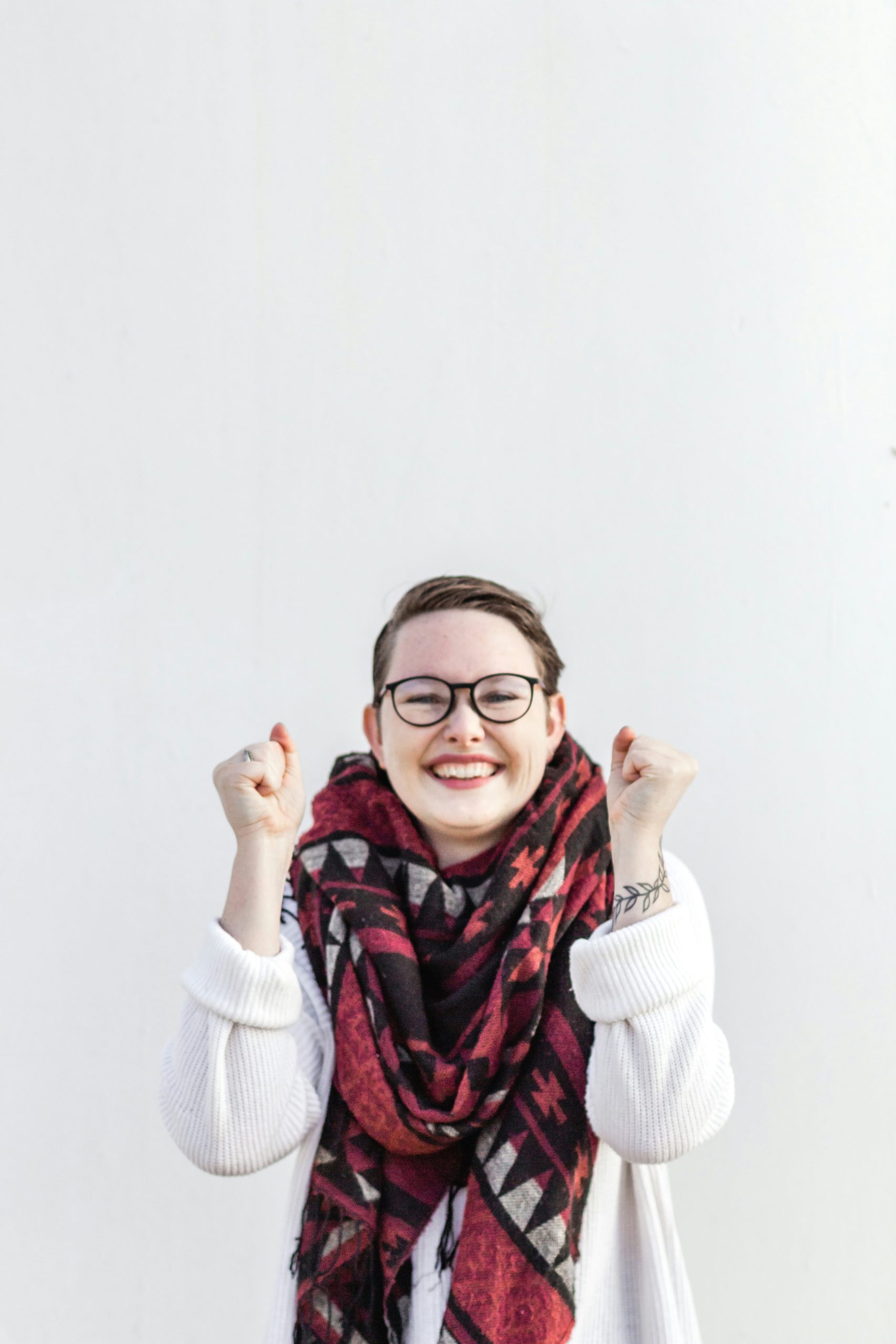 A woman cheering and looking happy.