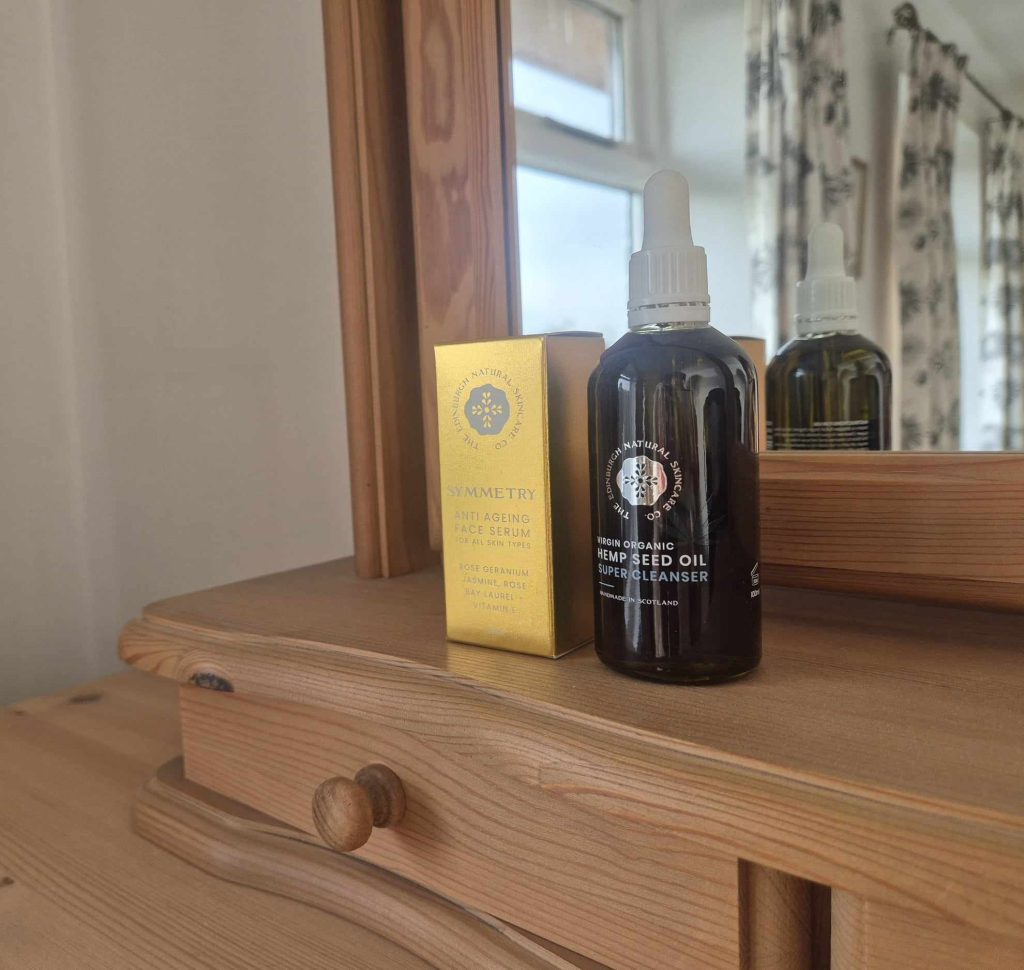 Two skincare products by The Edinburgh Natural Skincare Company on a dressing table.