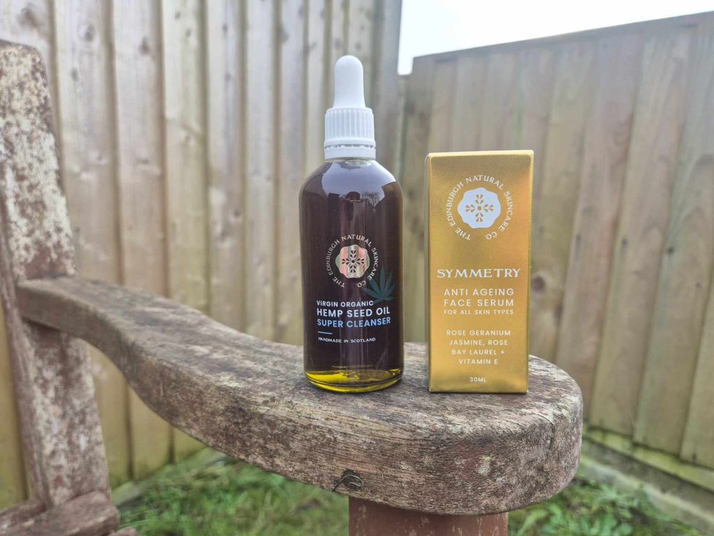 A bottle of The Edinburgh Natural Skincare Company Virgin Organic Hemp Seed Oil Super Cleanser and a box containing the Symmetry Anti Ageing Face Serum
