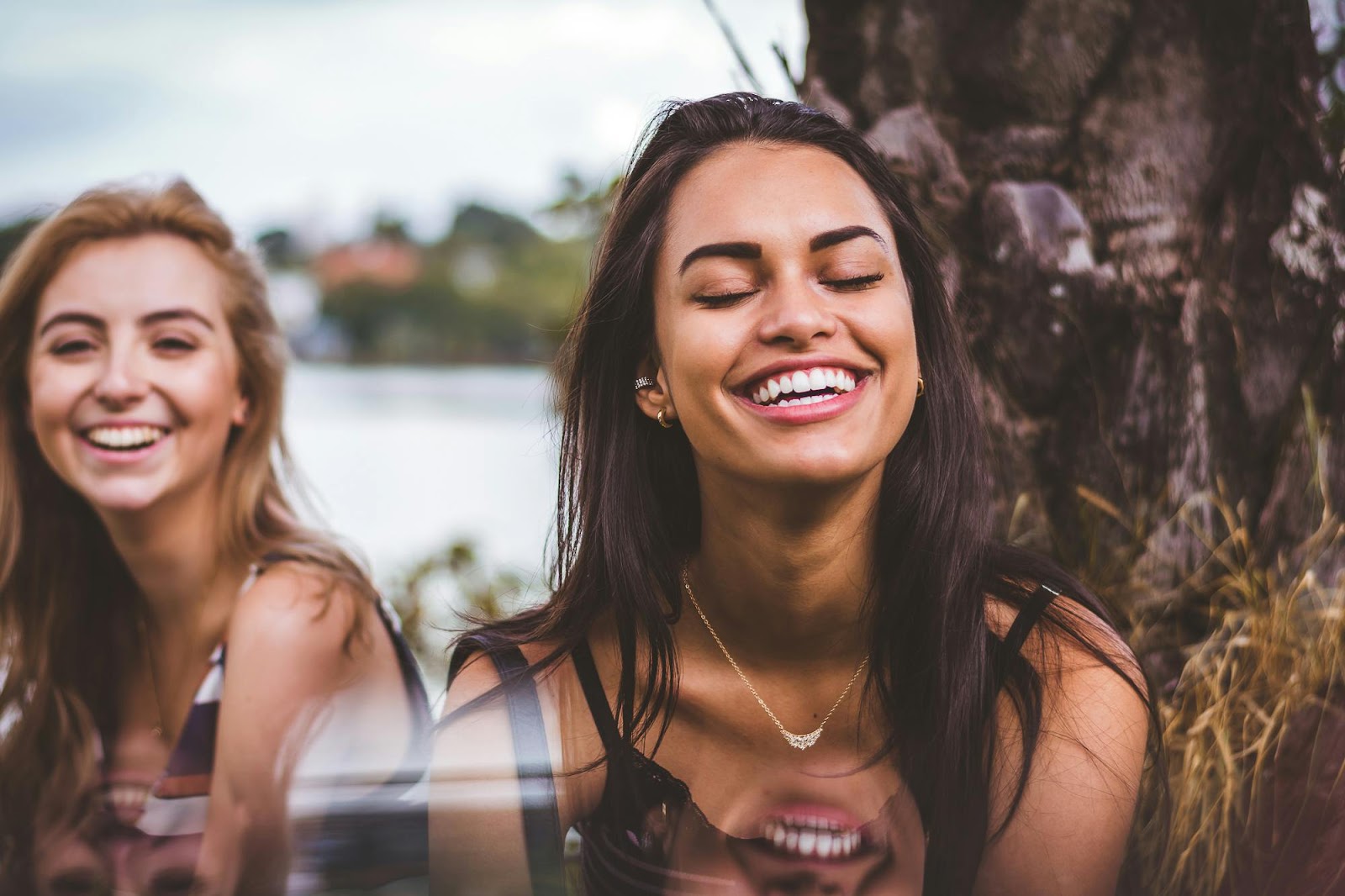 Two women smiling and laughing together.