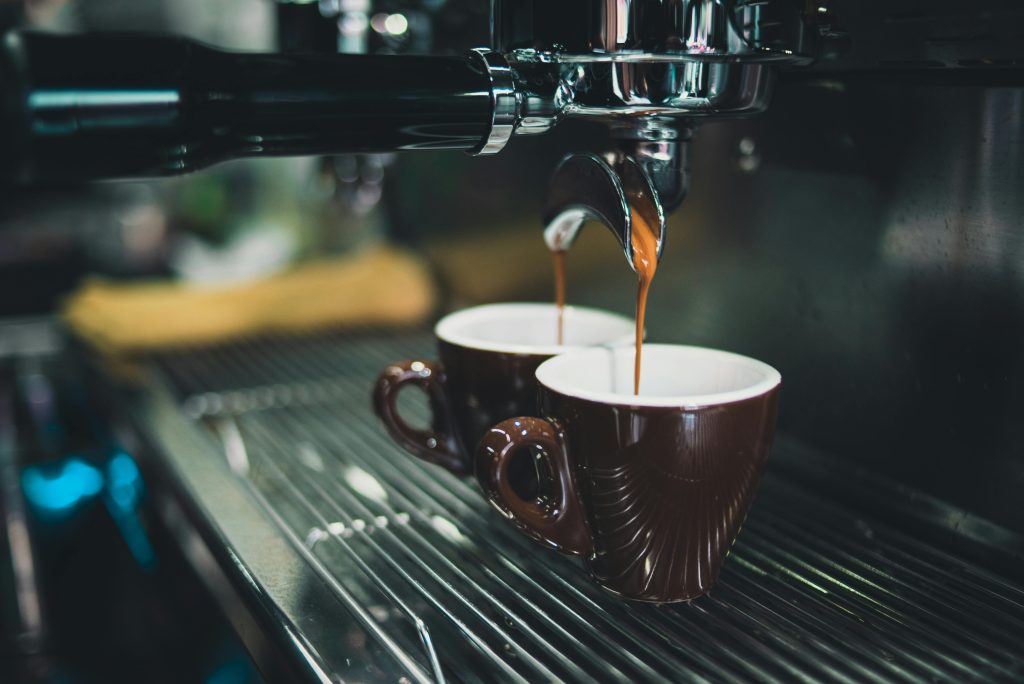 A coffee machine in the process of making two cups of coffee.