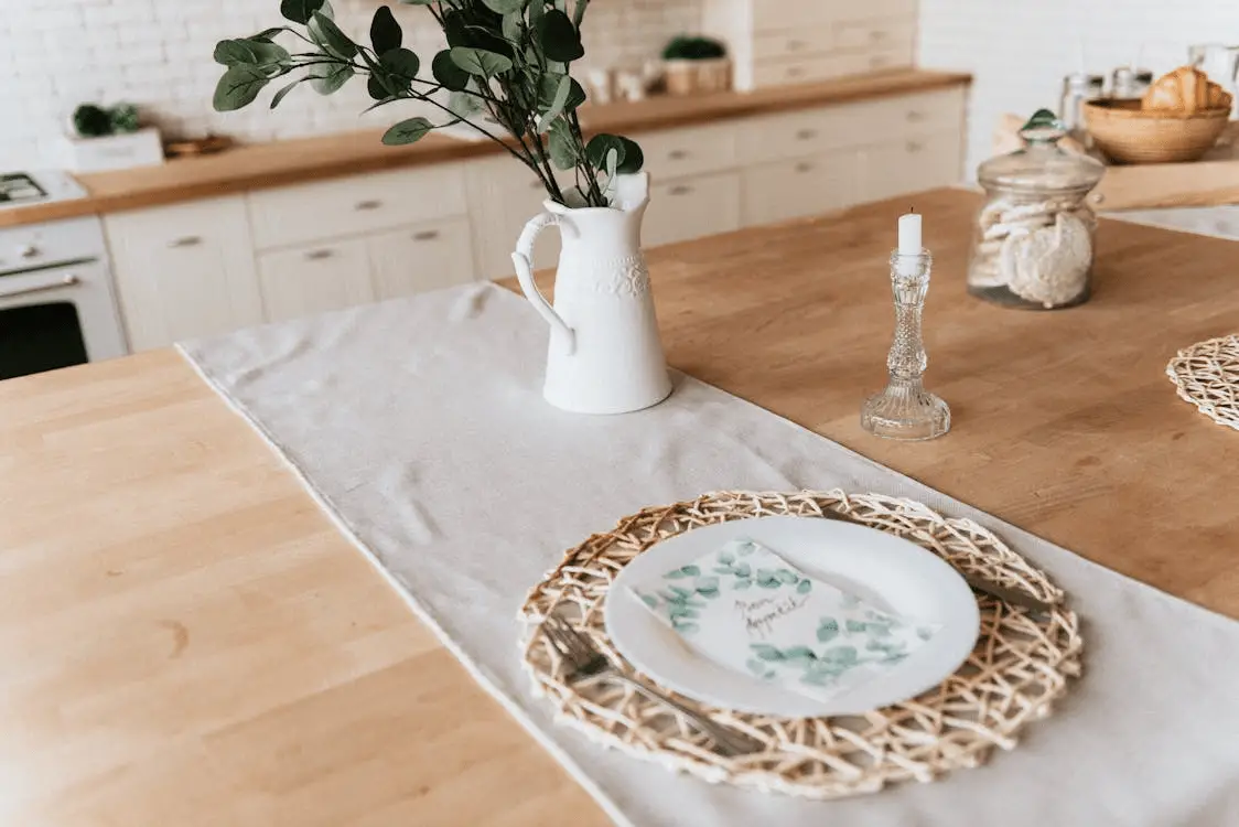 A kitchen worktop and island set out with decorative items.